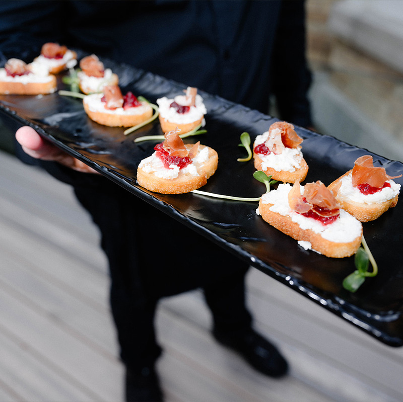 smoked-salmon-canapes-on-a-black-rectangular-plate