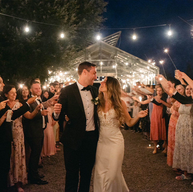 bride-and-groom-celebrating-under-an-awning-of-sparkling-lights