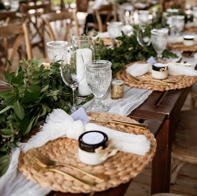 hawley-crescent-table-setting-rattan-risers-white-candles-gold-cutlery